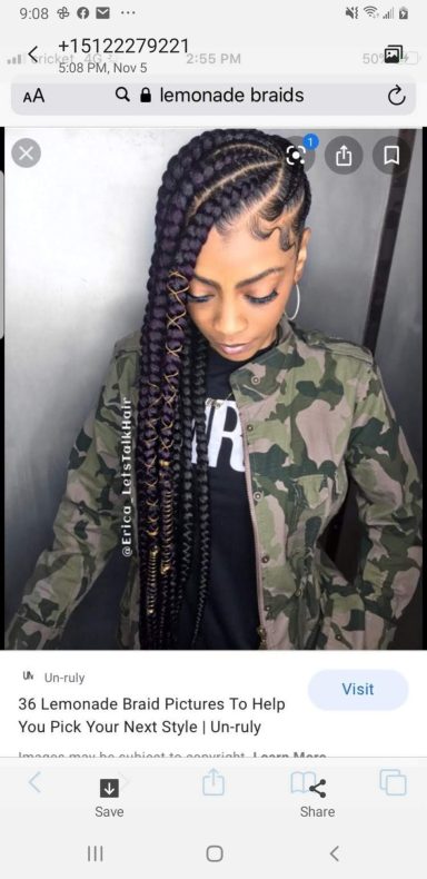 A person with long braids wearing a camo jacket and a black shirt, looking downward.