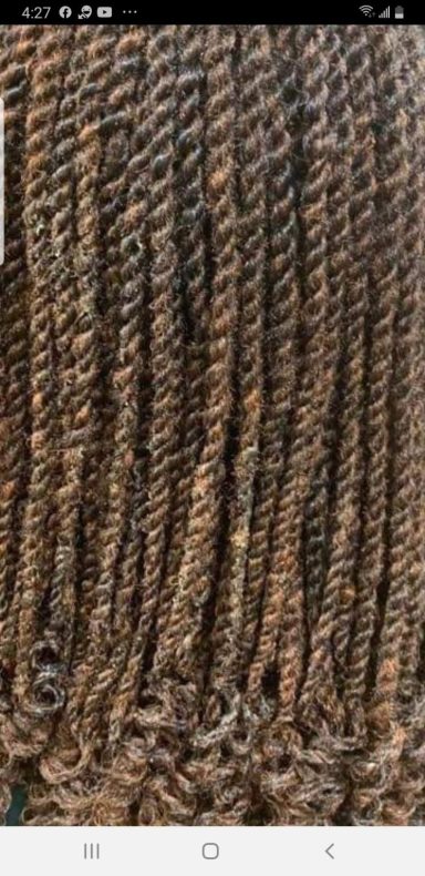 Close-up of twisted brown hair strands with a shiny texture.